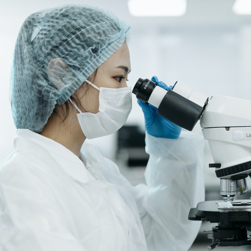 Scientist looking through a microscope